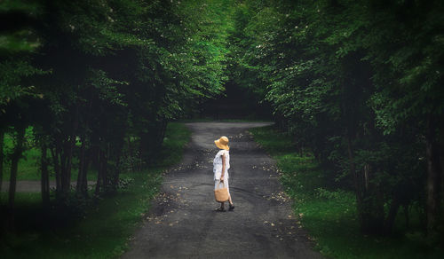 Rear view of woman walking in forest