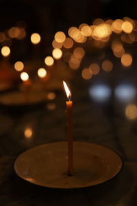 Close-up of lit candles on table