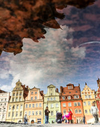 Low angle view of buildings against cloudy sky