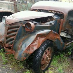 Abandoned car on field