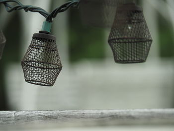 Close-up of metal tied hanging on wood