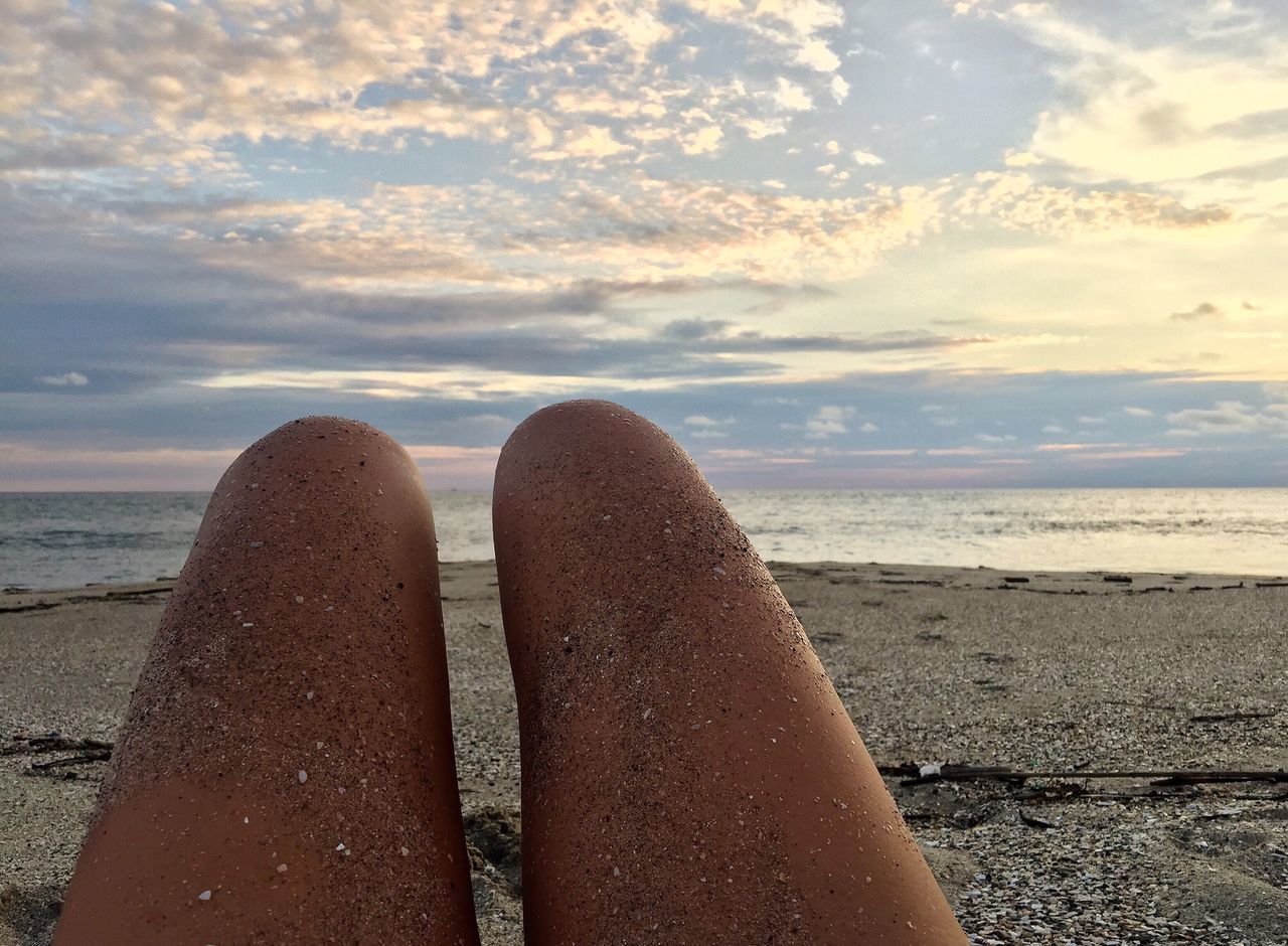 sea, low section, human leg, beach, relaxation, water, human foot, horizon over water, one person, leisure activity, cloud - sky, sky, vacations, barefoot, real people, personal perspective, nature, sand, lifestyles, human body part, beauty in nature, outdoors, close-up, summer, one woman only, scenics, day, adults only, adult, only women, people