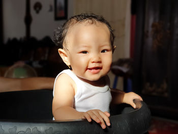 Portrait of cute girl sitting at home