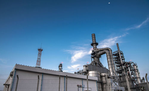 Low angle view of factory against sky