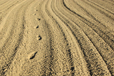 Full frame shot of tire tracks on sand