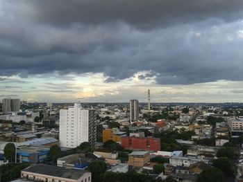 Buildings against cloudy sky