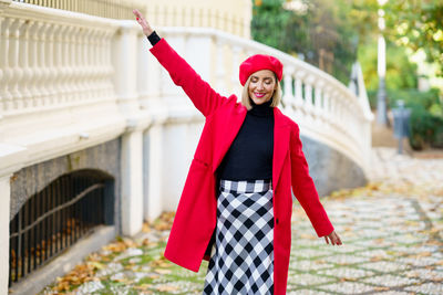 Portrait of young woman standing in city