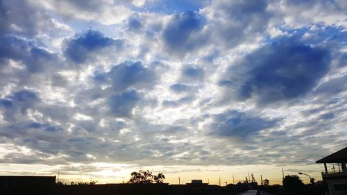 Low angle view of silhouette trees against sky