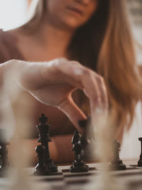 Midsection of woman playing chess