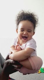 Portrait of cute girl holding hair at home