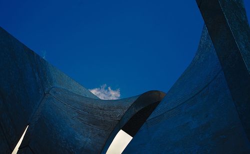 Low angle view of mountain against blue sky