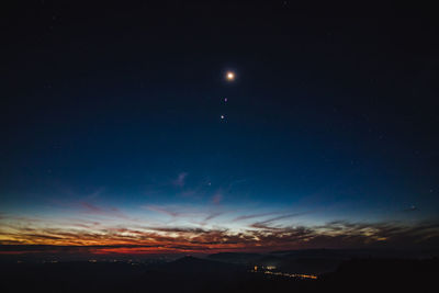 Scenic view of silhouette landscape against sky at night