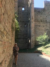 Woman standing against wall