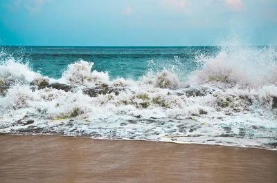Scenic view of sea waves splashing on shore