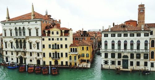 Boats in river with buildings in background