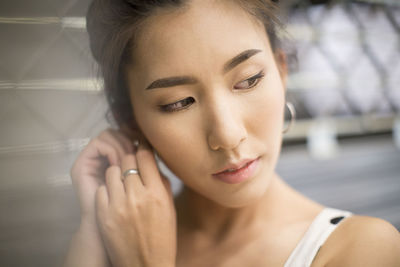 Close-up of young woman looking away while wearing earring
