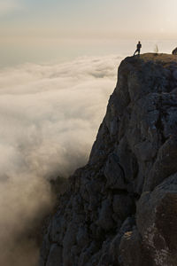 Tourist cliff mountain. silhouette against the background of bright sunlight. 