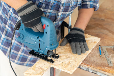 Low section of man working at workshop