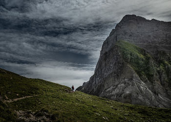 Man on rock against sky