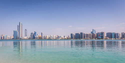 View of swimming pool by buildings against sky