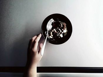 Cropped image of woman holding mirror reflecting in mirror