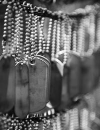 Close-up of dog tags hanging for sale