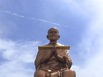 Low angle view of statue against blue sky