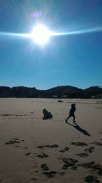Silhouette man on beach against clear sky
