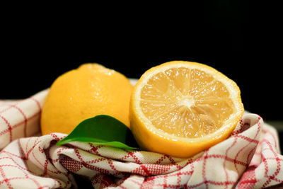 Close-up of orange fruits against black background