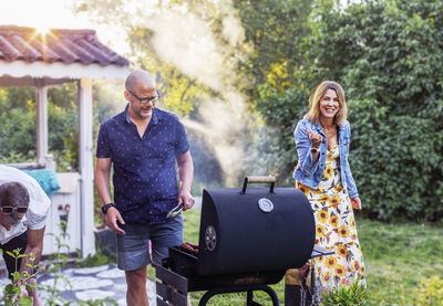 People having barbecue in garden