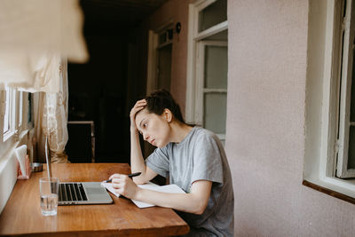 Young woman using laptop at home