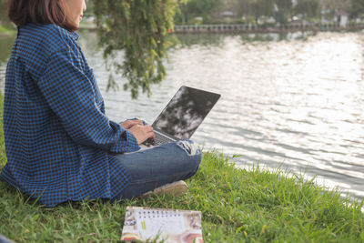 Midsection of woman using digital tablet