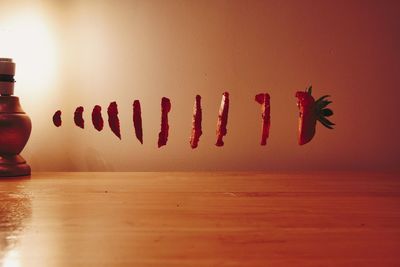 Close-up of fork on table against wall