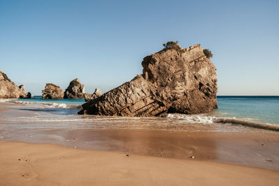 Scenic view of sea against clear blue sky