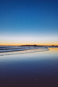 Scenic view of calm sea against clear blue sky