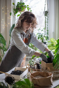 Portrait of young woman gardening