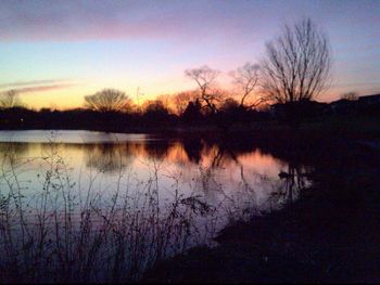 Scenic view of calm lake at sunset