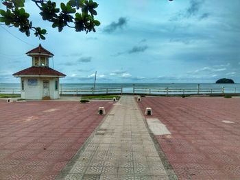 Lifeguard hut by sea against sky