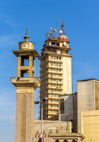 Low angle view of clock tower against sky in city