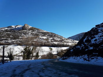 Scenic view of snowcapped mountain against clear blue sky