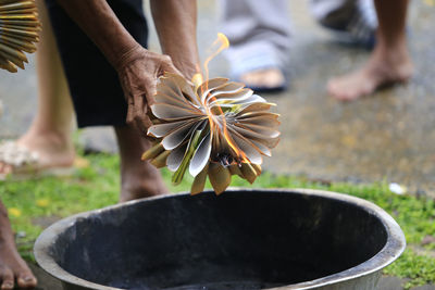 Old man holdind the burning funeral rite paper to pray for dead peopel.