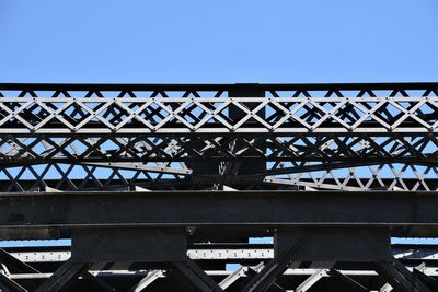 Low angle view of bridge against blue sky