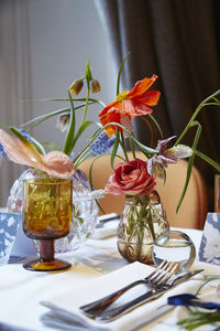 Close-up of flowers in vase on table in restaurant