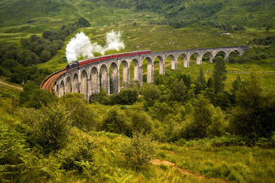 Aerial view of train on arch bridge