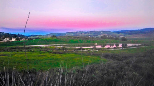 Scenic view of field against sky during sunset