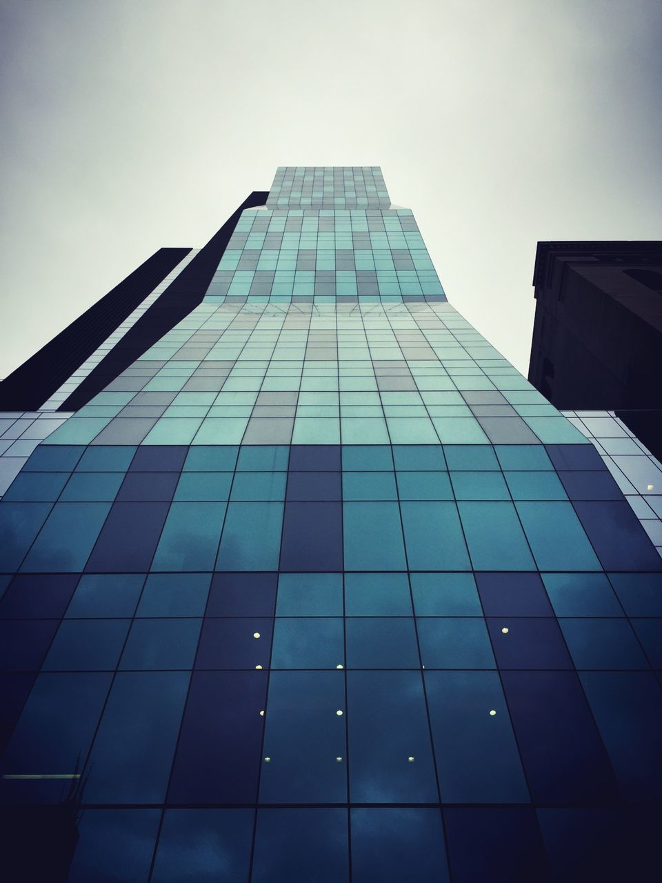 architecture, building exterior, built structure, low angle view, modern, office building, skyscraper, tall - high, city, tower, glass - material, reflection, sky, building, clear sky, day, tall, architectural feature, outdoors, no people