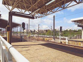 Train at railroad station against sky