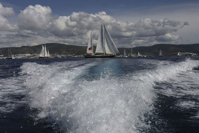 Sailboat sailing on sea against sky