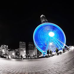 Illuminated ferris wheel at night
