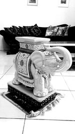 High angle view of statue on tiled floor at home